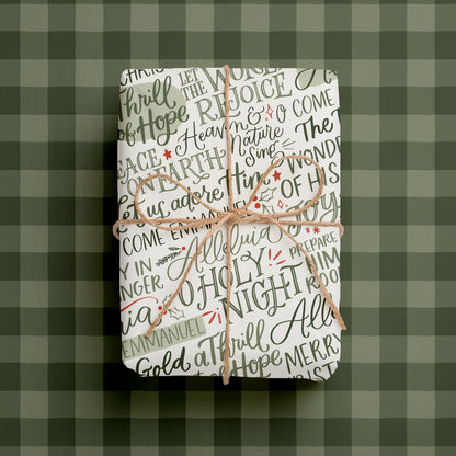 Double-sided Christmas Christian  wrapping paper sheets with hand-lettered phrases with green buffalo check plaid.